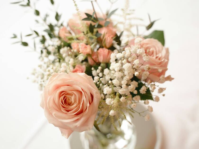 A wedding bouquet with pink and white flowers.