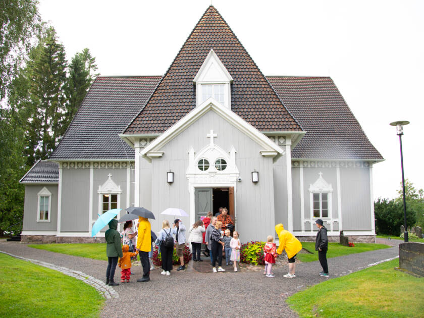 Ihmisiä Tuusulan kirkon edessä